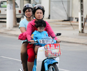 Three people on a scooter in Vietnam